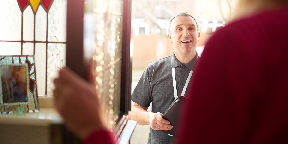 A man with an ID at the door of a resident.