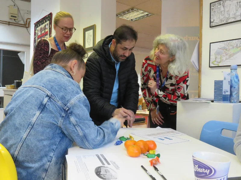 Residents speak to ISHA staff at an event. 