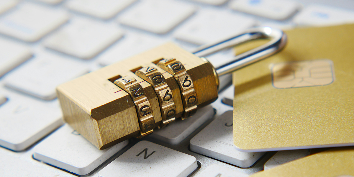 A padlock and SIM cards on top of a computer keyboard.