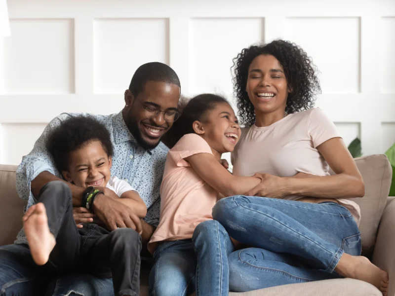 Happy family play on a couch. 