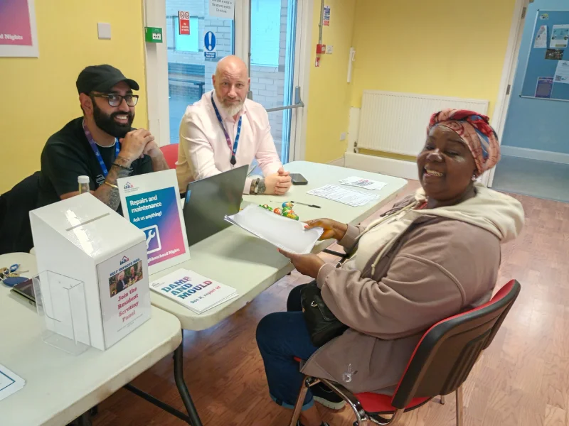 ISHA staff engaging with a resident at one of our events.