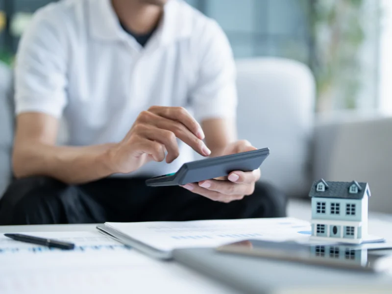 A man calculates his home finances. 