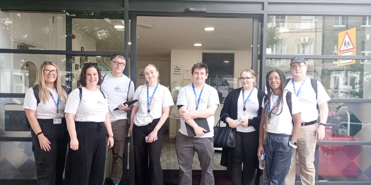 ISHA staff gathered outside the office, smiling ahead of the neighbourhood knock.
